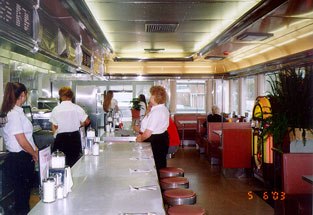 Minutes before the Ribbon Cutting ceremony - waitresses take care of last minute details